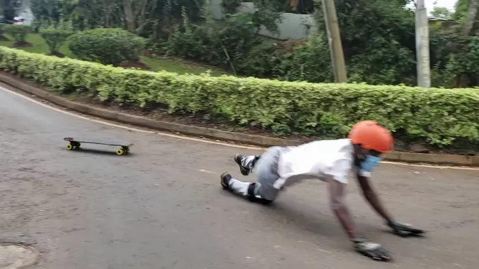 downhill longboarder demonstrating a knee slide