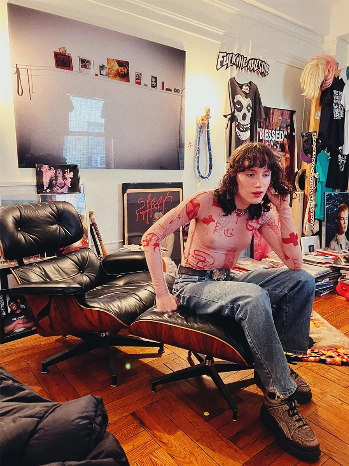 Efron Danzig looking thoughtfully into the distance while holding a skateboard.