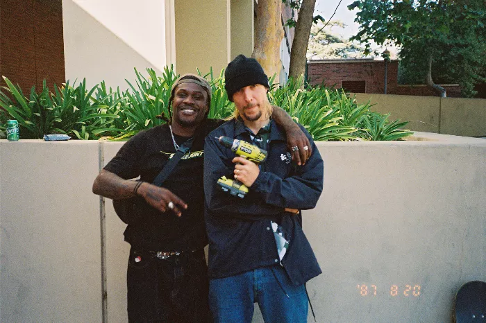 Erik Ellington posing with a power tool