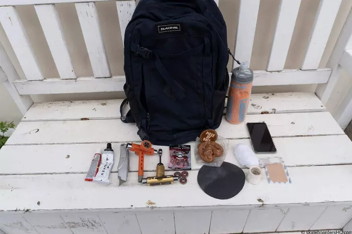 Essential skateboarding items and a backpack bag