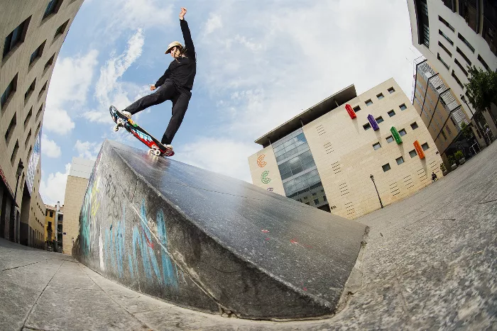 Fabiana Delfino performing a switch pivot fakie on a steep bank