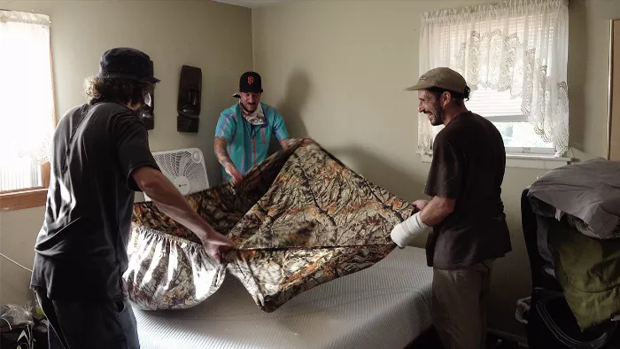 Fred Gall looking surprised as he is presented with a new mattress, part of a video celebrating his sobriety anniversary.