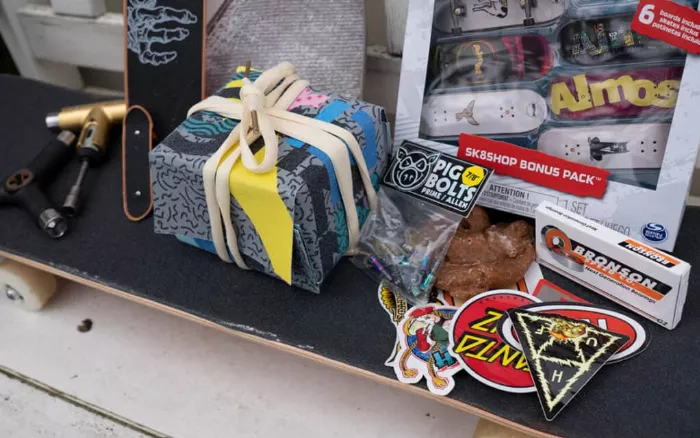 Gifts for longboarders arranged on a longboard