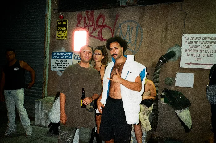 Group of people at a cutty party in Bushwick at the end of an empty block.