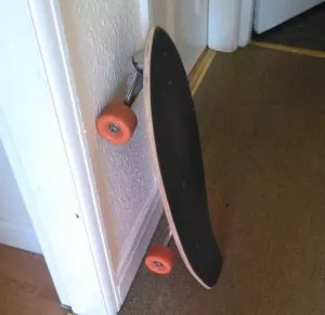 Image of a complete longboard with wheels, trucks, and deck