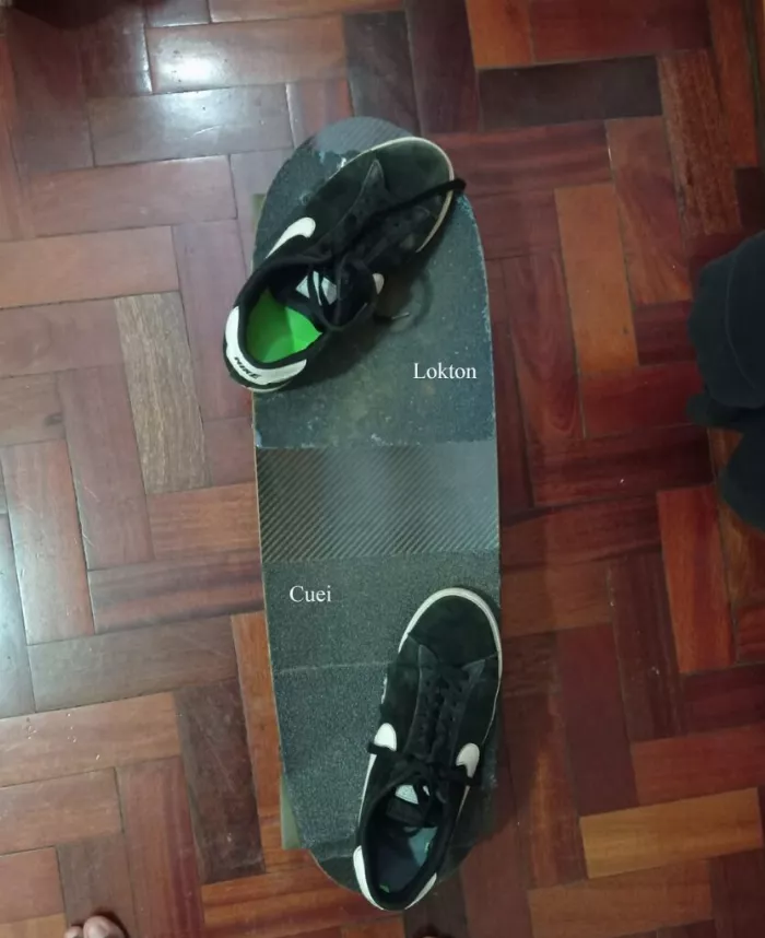 Image of a longboard with Lokton griptape on the front and Cuei griptape on the back