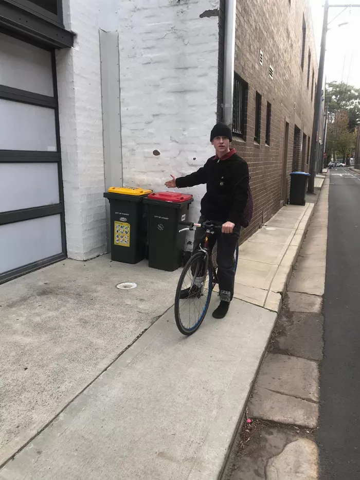 Jack O'Grady riding his skateboard in an alley