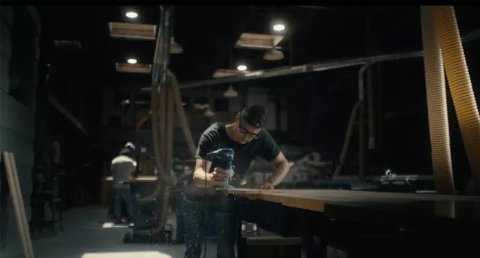 James crafting a longboard in his workshop