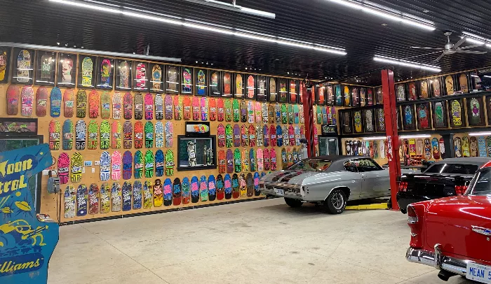 James Lamb surrounded by his skateboard deck collection