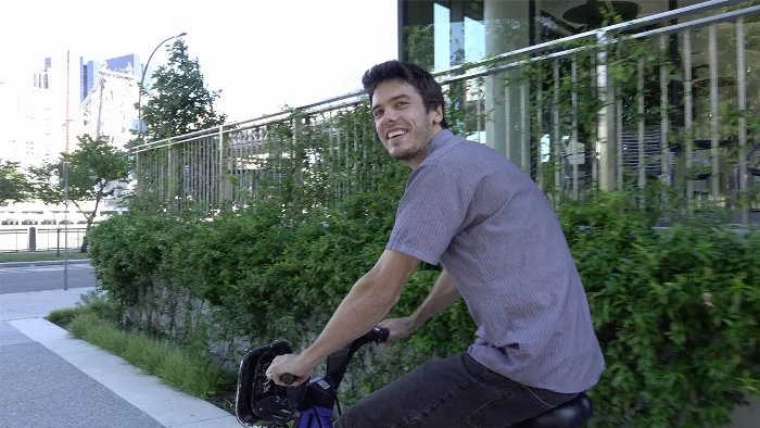 Jerome Peel performing a trick on a Citi Bike at the Roosevelt Island monument