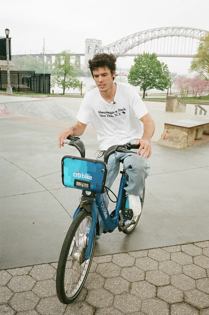 Jerome Peel performs a trick on a Citi Bike, showcasing his skills and the bike's unwieldy nature