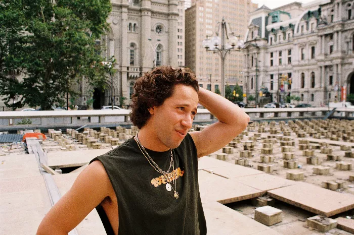 Joey Marrone at a skate event, smiling with a beer in hand