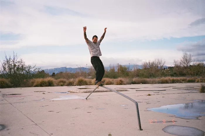 Jud Farhat skating on a DIY rail