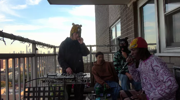 Kyota Umeki performing a live DJ set on his balcony, showcasing the NYC skyline in the background