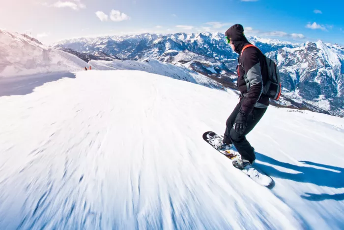 Longboarder carving down a paved road