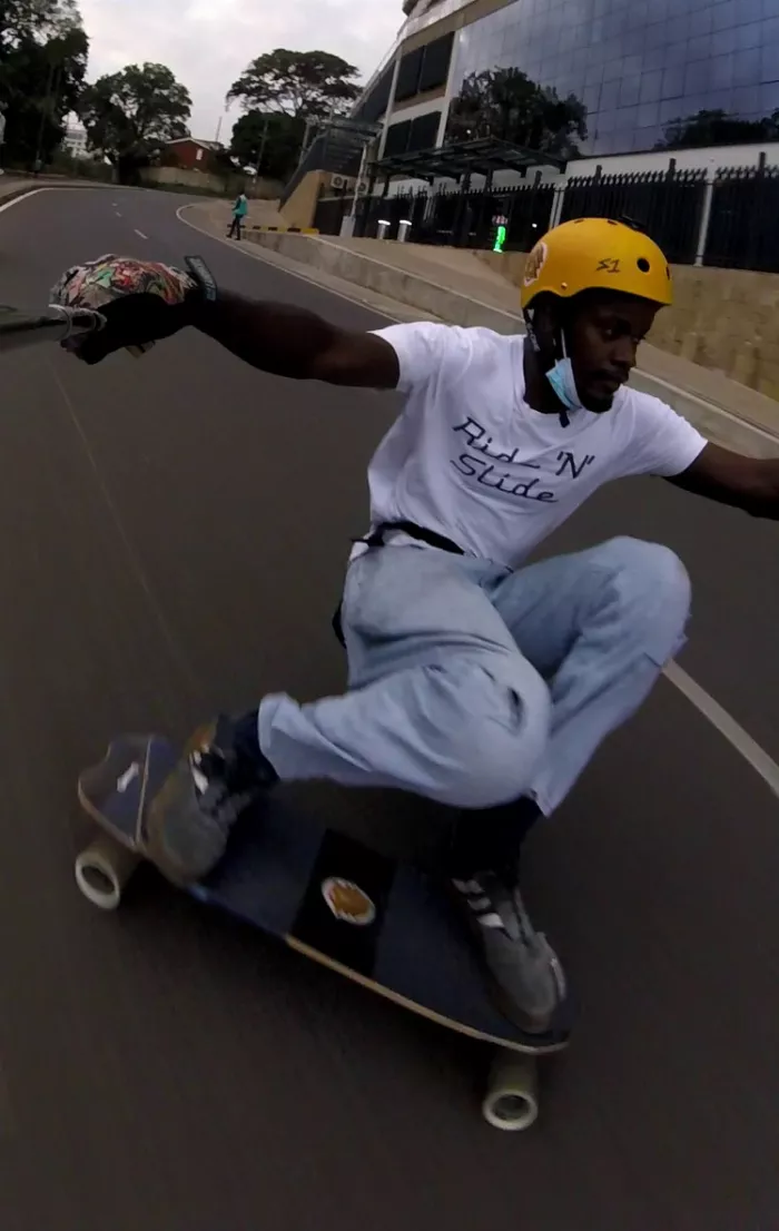 Longboarder squat sliding on the El Peligro with Pro-Fluxx wheels