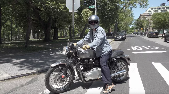 Marcello Campanello standing next to his Triumph motorcycle in Astoria, Queens