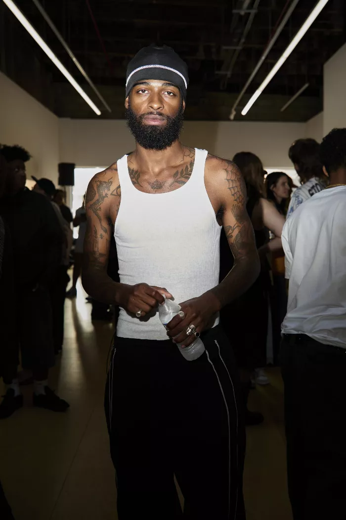 Model Holding Water Bottle at Art Show