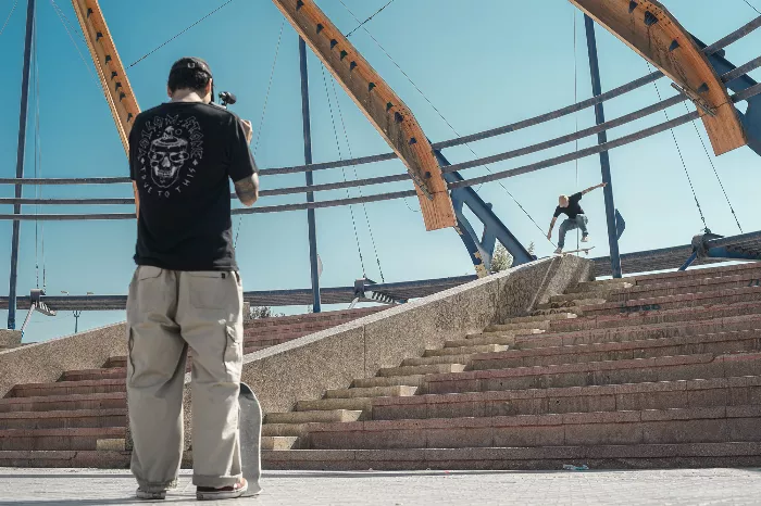 Nicolas Garay leaning on a ramp while filming a skateboarder.