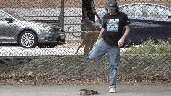 Person stretching their leg while sitting on a skateboard