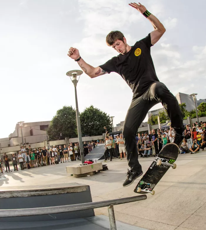 Professional skateboarder Chris Cole, standing on his board.