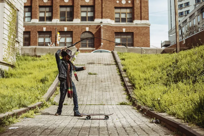 Rick Ross, the longboarding cowboy, cracking his whip while riding in Philly