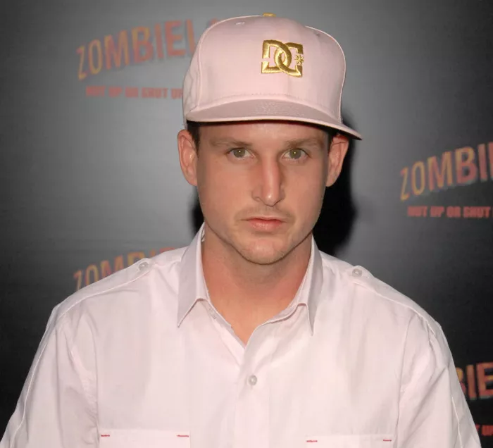 Rob Dyrdek posing with his skateboard