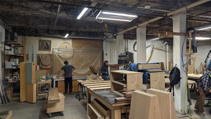 Rob Pluhowski in his workshop, surrounded by tools and materials, embodying his new career