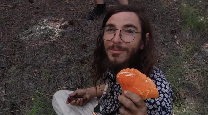 Ryan Reyes holding a variety of foraged mushrooms