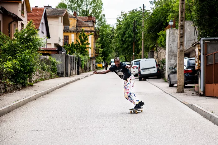 Shredmaster Keith skating in a public space in Bulgaria with classic architecture and monuments in the background