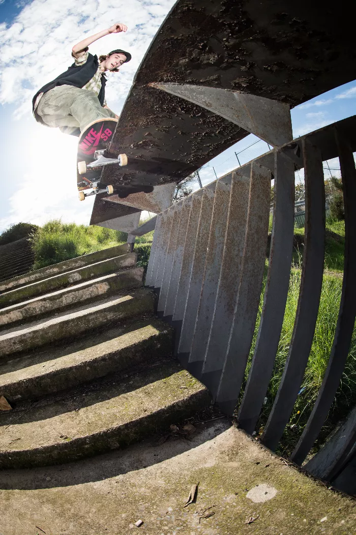 Simon Isaksson skating, captured mid-air with his board, showcasing his unique style and skill.