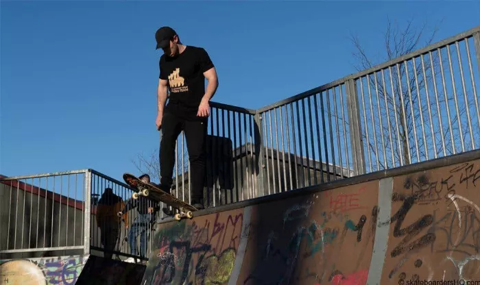 skateboarder about to drop in a quarter pipe