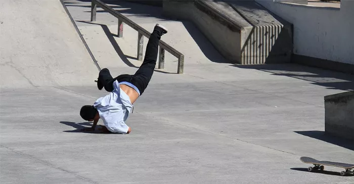 skateboarder falling on concrete