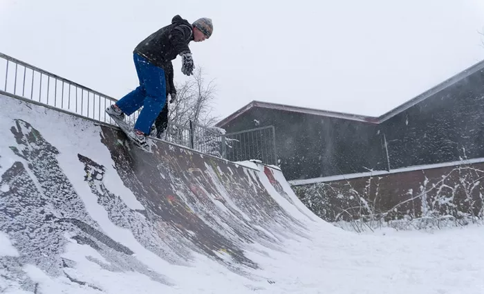 skateboarder in a mini ramp and snow