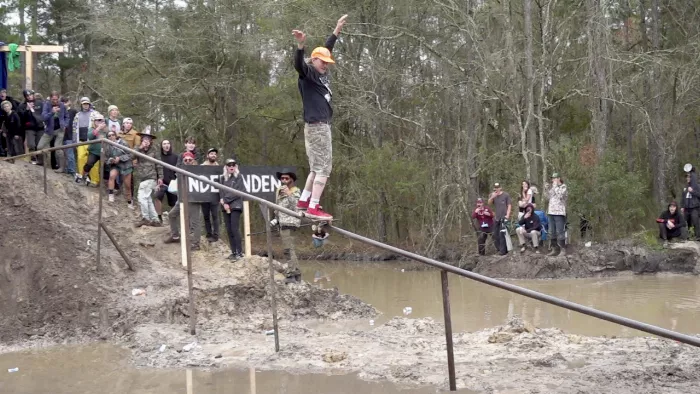 Skateboarder riding a rail at Swampfest