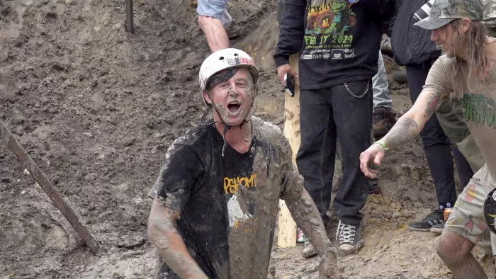 Skateboarder slamming into the mud at Swampfest