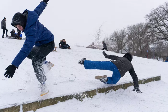 Skateboarders having fun in the winter snow