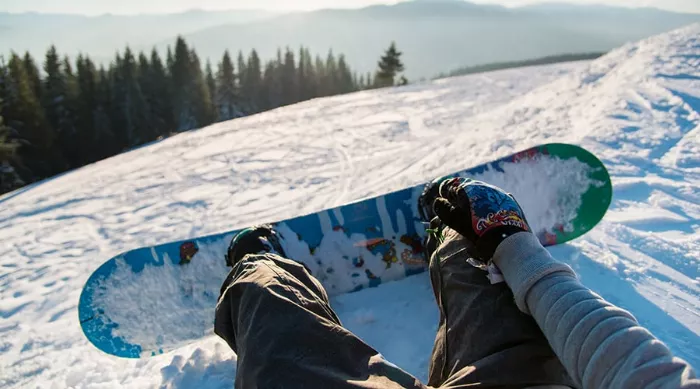 Snowboard leaning against a mountain backdrop