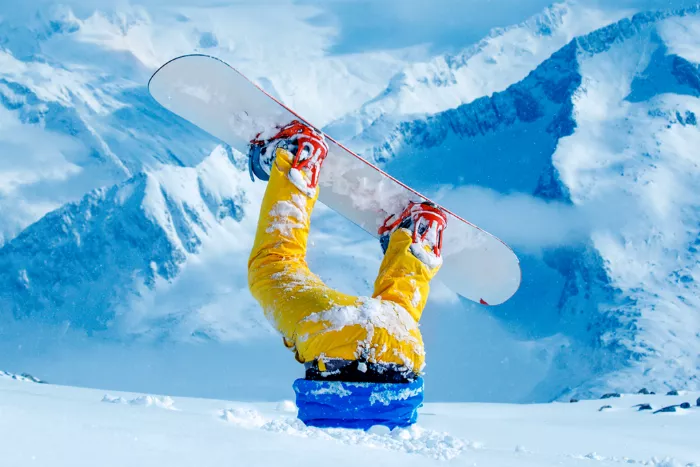 snowboarder upside down in snow