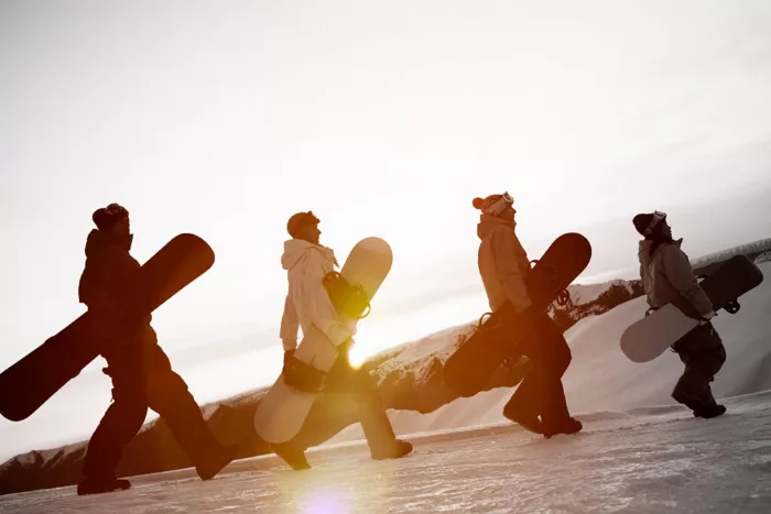 Snowboarders with different types of snowboards