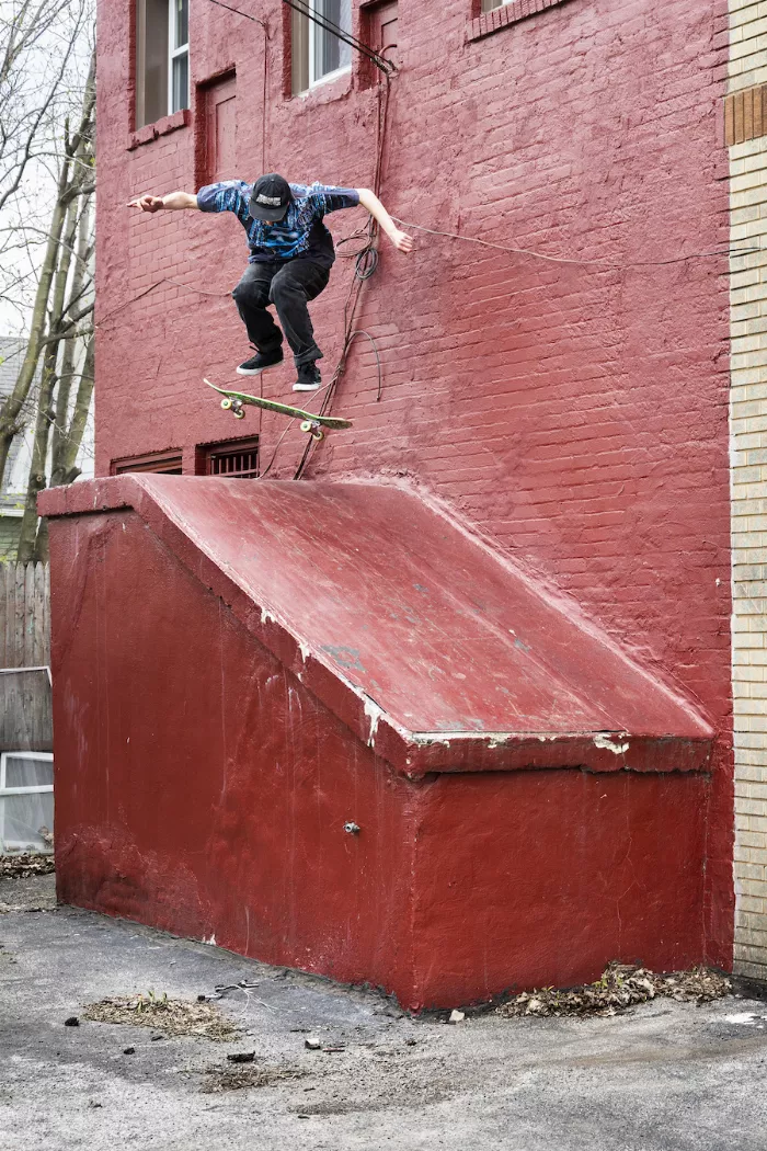 Steven performing a pop shuvit, showcasing his unique style on a skateboard