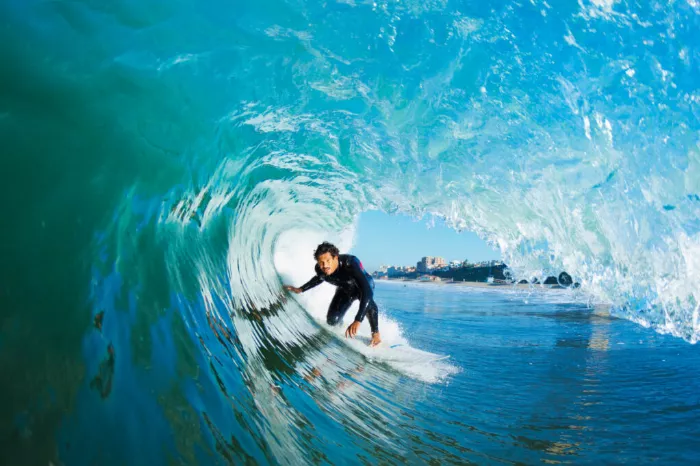 Surfer duck diving under a wave