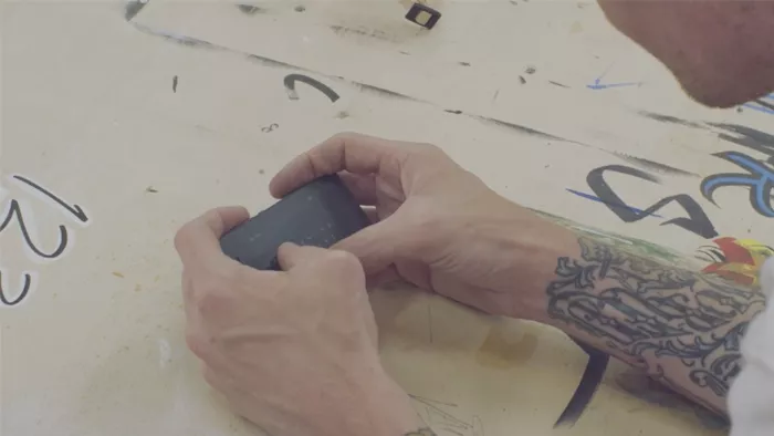 The Light Phone displayed on a table with various everyday objects, emphasizing its minimalist concept