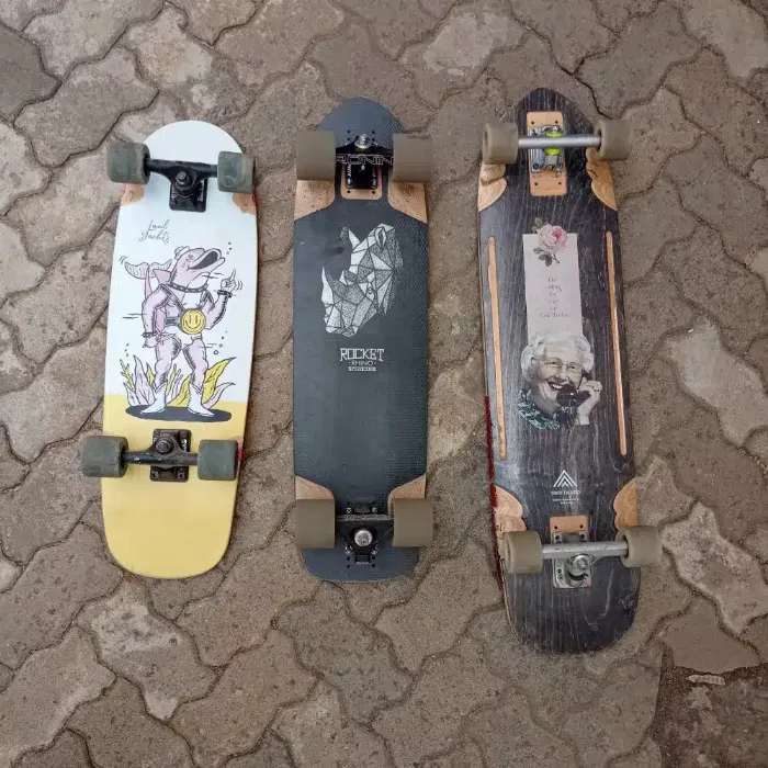 Three different types of longboards: cruiser, downhill, and freeride