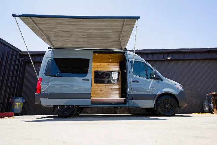 TJ Gaskill standing in front of a converted van