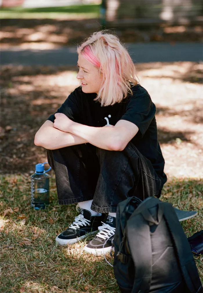 Tobi Stanley looking fashionable, holding a skateboard.