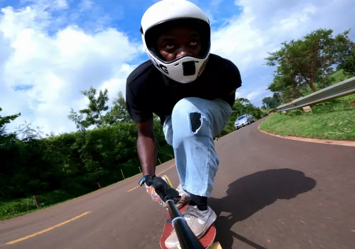 tuck leaning on a longboard