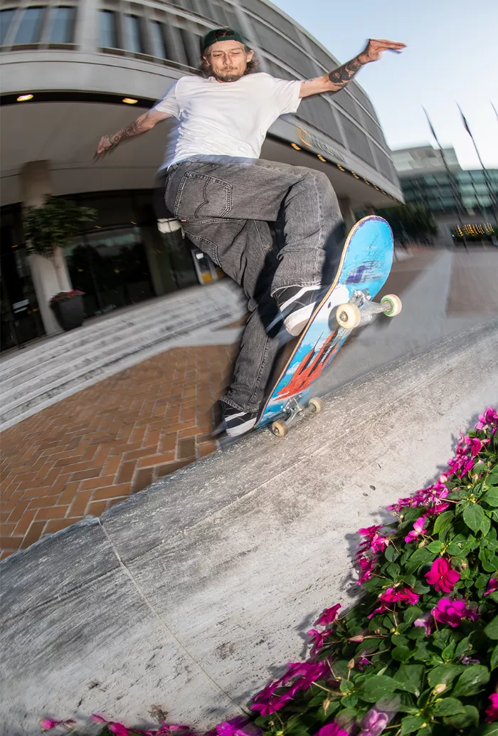 Tyler Bledsoe performing a frontside blunt slide on a skateboard