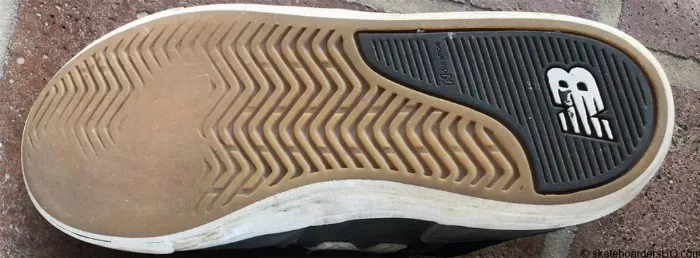 Worn New Balance skate shoes, showing sole wear and tear after extended use